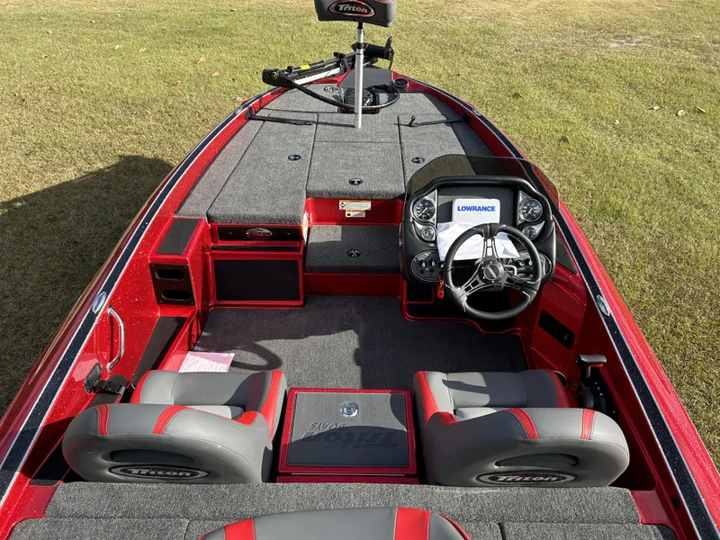 Slide: The Image of 2024 Triton 179 TrX boat interior with steering console and seating. - 12