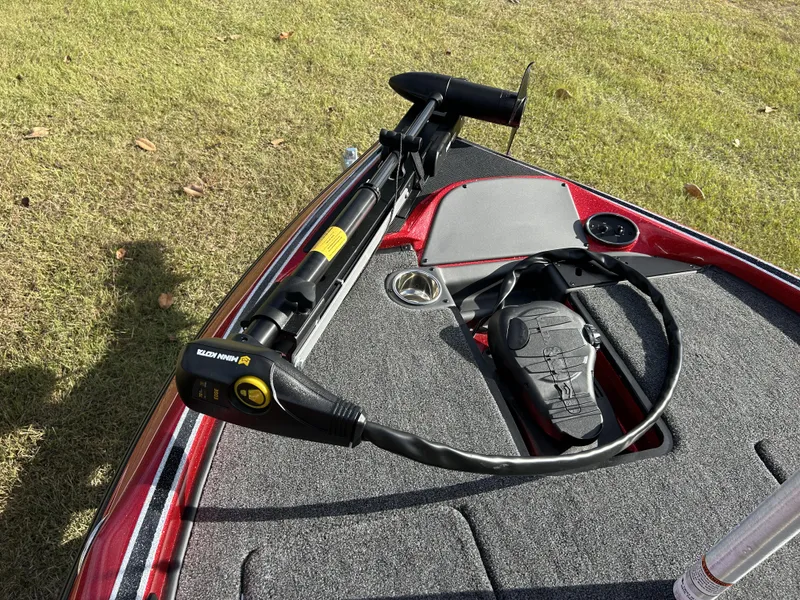 Slide: The Image of 2024 Triton 179 TrX boat with Minn Kota trolling motor on grassy area. - 5