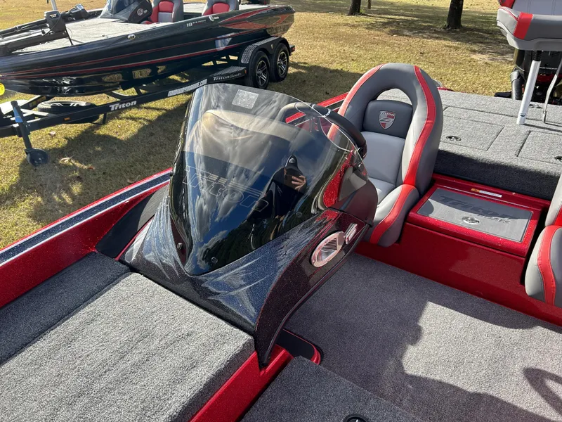 Slide: The Image of 2024 Triton 179 TrX bass boat interior with windshield and seating. - 6