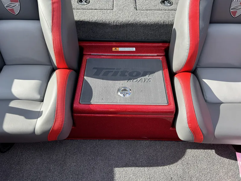 Slide: The Image of 2024 Triton 179 TrX boat interior with red and gray seats. - 7