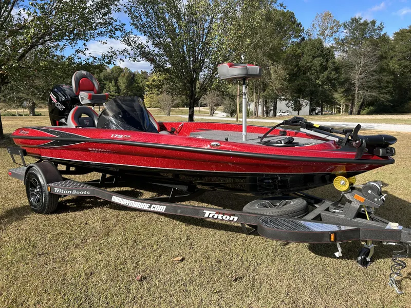 Slide: The Image of 2024 Triton 179 TrX bass boat in red on a trailer. - 8
