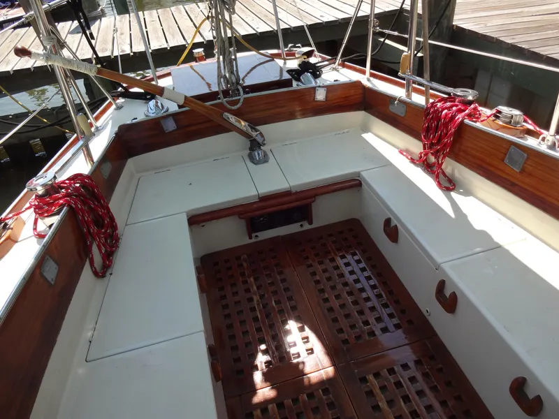 Slide: The Image of 1966 Cheoy Lee 36 Offshore Flying Buffalo sailboat cockpit with wooden accents and red ropes. - 14