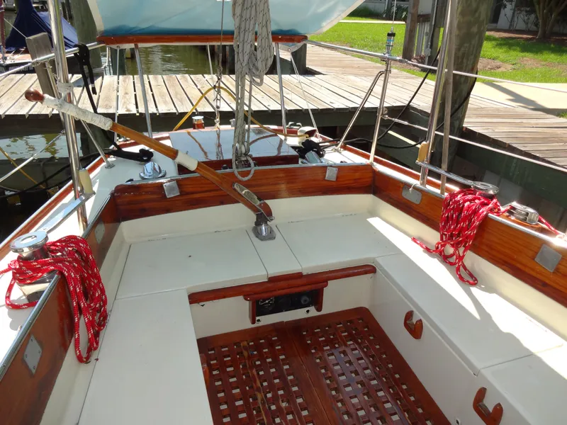 Slide: The Image of 1966 Cheoy Lee 36 Offshore Flying Buffalo sailboat cockpit with wooden accents and red ropes. - 15