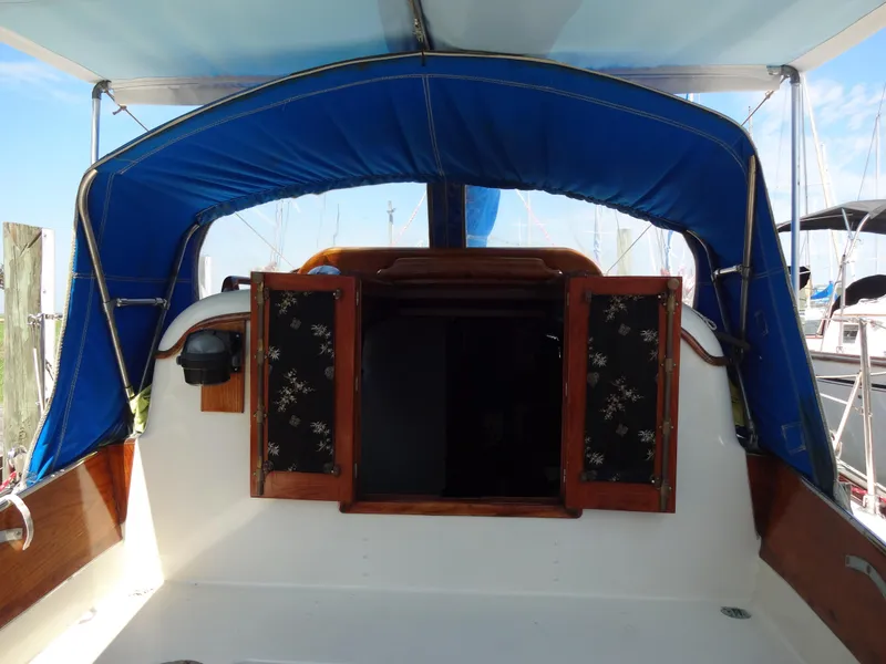 Slide: The Image of 1966 Cheoy Lee 36 Offshore Flying Buffalo sailboat cockpit with blue canopy and wooden doors. - 16