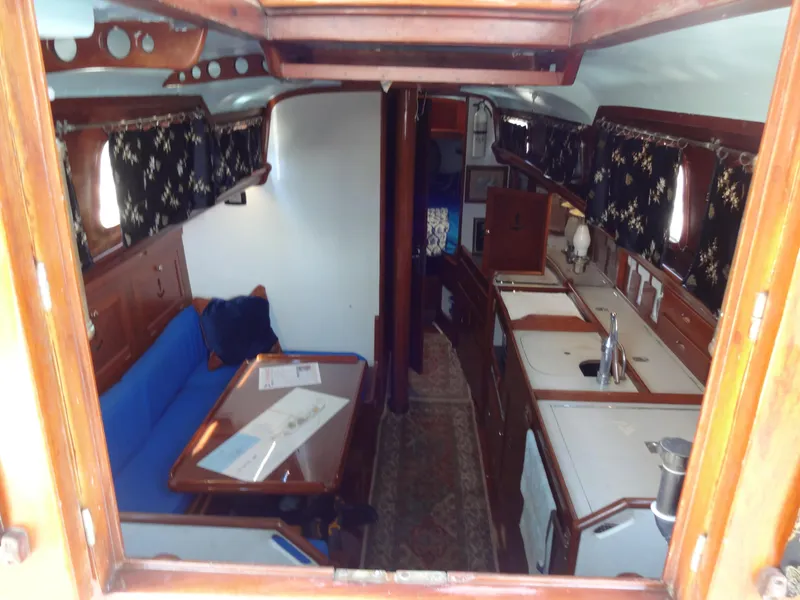 Slide: The Image of Interior of 1966 Cheoy Lee 36 Offshore Flying Buffalo yacht with wood finish and blue seating. - 17