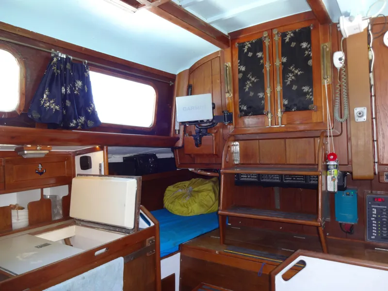 Slide: The Image of Interior of 1966 Cheoy Lee 36 Offshore Flying Buffalo yacht with wooden cabinetry and nautical decor. - 19