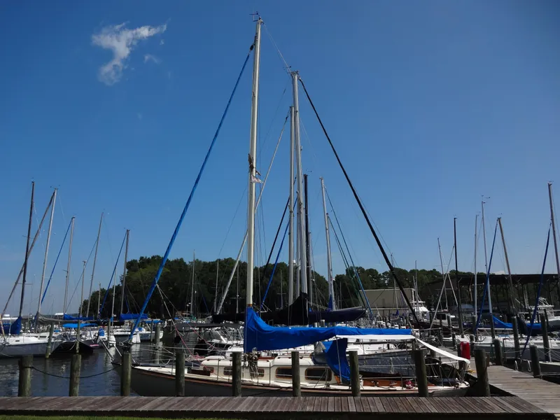 Slide: The Image of 1966 Cheoy Lee 36 Offshore Flying Buffalo sailboat docked at a marina under clear blue sky. - 2