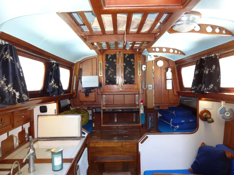 Slide: The Image of Interior of 1966 Cheoy Lee 36 Offshore Flying Buffalo yacht, featuring wood paneling and nautical decor. - 20