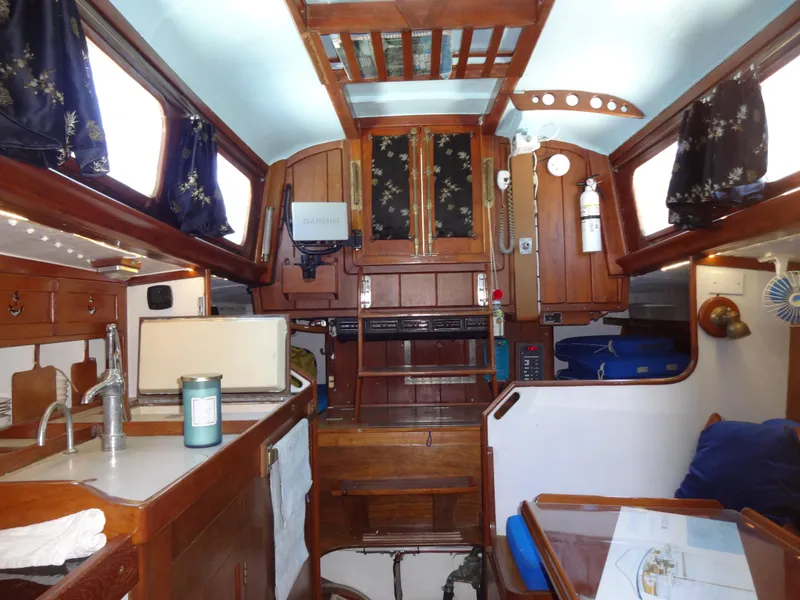 Slide: The Image of Interior of 1966 Cheoy Lee 36 Offshore Flying Buffalo sailboat, featuring wood cabinetry and nautical decor. - 21