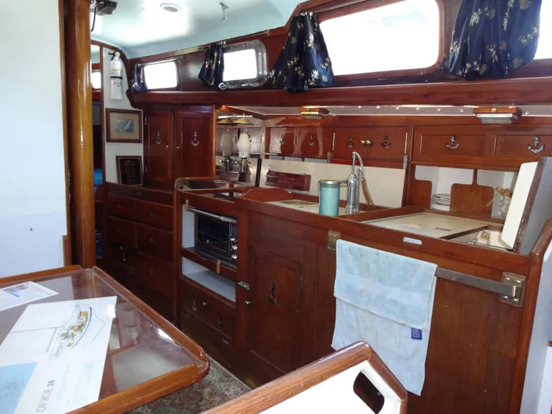 Slide: The Image of Interior of 1966 Cheoy Lee 36 Offshore Flying Buffalo yacht, featuring wooden cabinetry and nautical decor. - 23