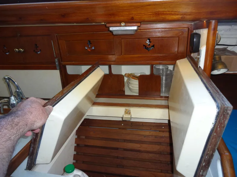 Slide: The Image of Interior of 1966 Cheoy Lee 36 Offshore Flying Buffalo with wooden cabinetry and storage. - 25
