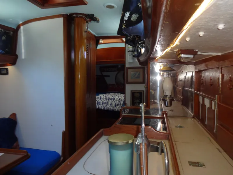 Slide: The Image of Interior of 1966 Cheoy Lee 36 Offshore Flying Buffalo yacht, featuring wood finishes and cozy cabin. - 30