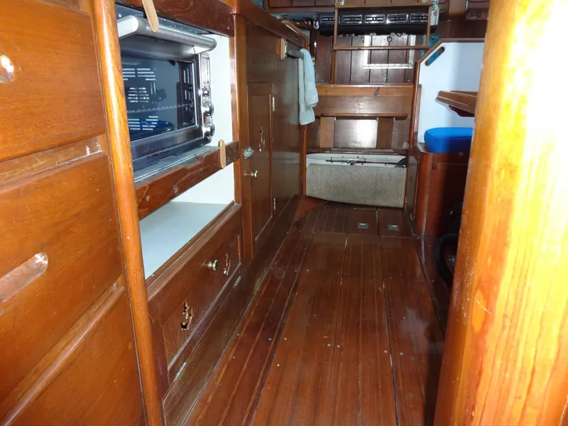 Slide: The Image of Interior of 1966 Cheoy Lee 36 Offshore Flying Buffalo, featuring wooden cabinetry and flooring. - 43