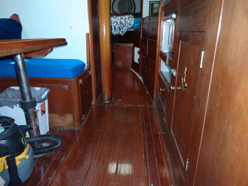 Slide: The Image of Interior of 1966 Cheoy Lee 36 Offshore Flying Buffalo with wooden furnishings and blue seating. - 45