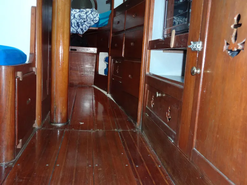 Slide: The Image of Interior of 1966 Cheoy Lee 36 Offshore Flying Buffalo, featuring polished wooden cabinetry and flooring. - 46