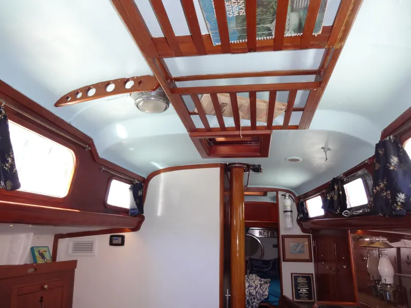 Slide: The Image of Interior of 1966 Cheoy Lee 36 Offshore Flying Buffalo sailboat with wooden accents and blue ceiling. - 47