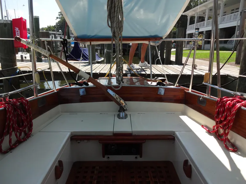 Slide: The Image of 1966 Cheoy Lee 36 Offshore Flying Buffalo sailboat cockpit with wooden accents and red ropes. - 7
