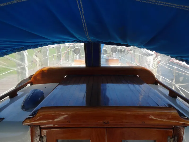 Slide: The Image of 1966 Cheoy Lee 36 Offshore Flying Buffalo yacht interior with blue canopy and wooden deck. - 9