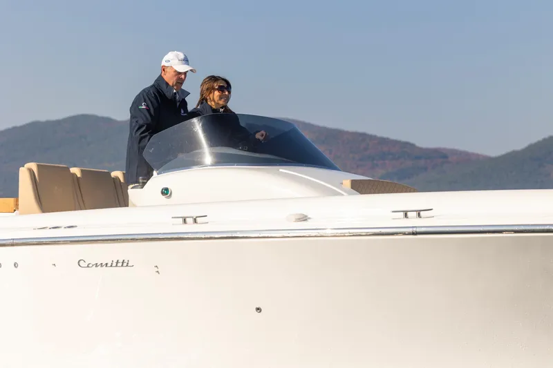 Slide: The Image of 2022 Comitti ISOLA 33 Sport SD boat with two people onboard. - 10
