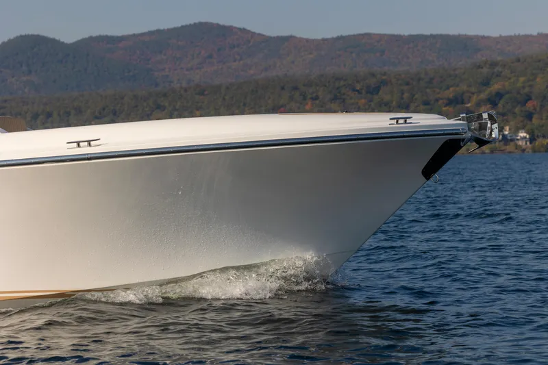 Slide: The Image of 2022 Comitti ISOLA 33 Sport SD cruising on a lake with scenic mountain backdrop. - 14