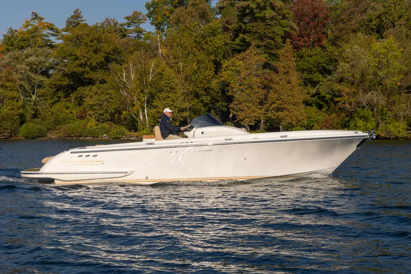 Slide: The Image of 2022 Comitti ISOLA 33 Sport SD cruising on a lake with forested background. - 15