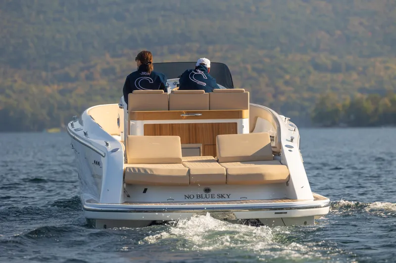 Slide: The Image of 2022 Comitti ISOLA 33 Sport SD boat cruising on a lake with two people onboard. - 16