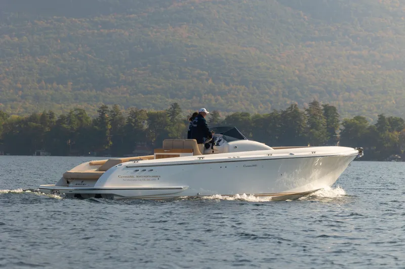 Slide: The Image of 2022 Comitti ISOLA 33 Sport SD cruising on a lake with scenic mountain backdrop. - 18
