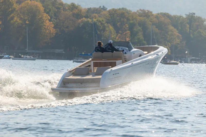 Slide: The Image of 2022 Comitti ISOLA 33 Sport SD cruising on a lake with autumn foliage in the background. - 20