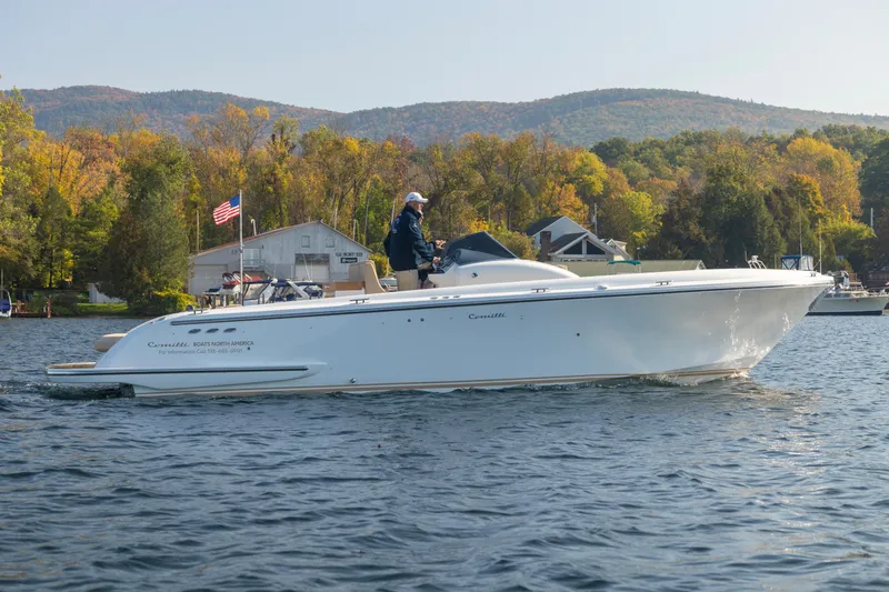 Slide: The Image of 2022 Comitti ISOLA 33 Sport SD boat cruising on a lake with autumn foliage. - 21