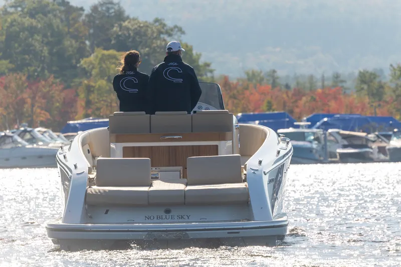 Slide: The Image of 2022 Comitti ISOLA 33 Sport SD boat on a lake with two people onboard. - 24