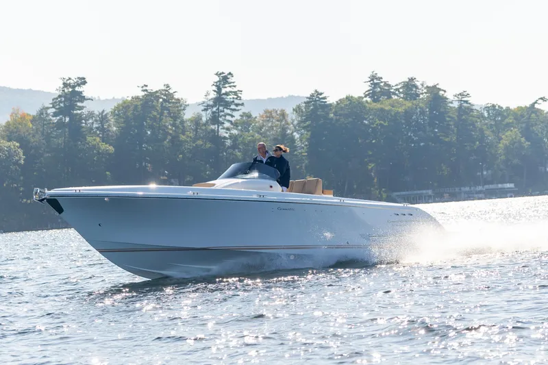 Slide: The Image of 2022 Comitti ISOLA 33 Sport SD cruising on a lake with forested background. - 27
