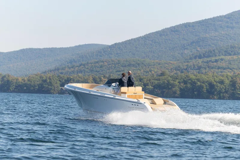 Slide: The Image of 2022 Comitti ISOLA 33 Sport SD cruising on a lake with scenic mountain backdrop. - 28