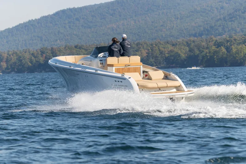 Slide: The Image of 2022 Comitti ISOLA 33 Sport SD cruising on a lake with forested hills in the background. - 29