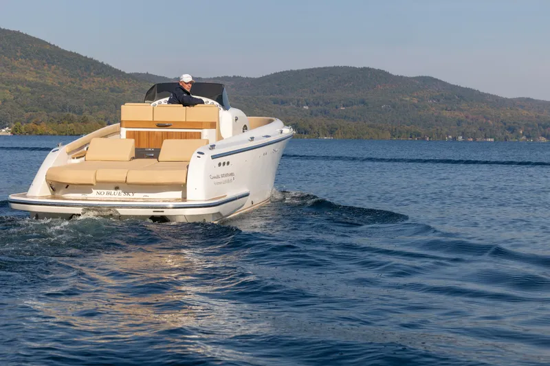 Slide: The Image of 2022 Comitti ISOLA 33 Sport SD cruising on a lake with scenic mountain backdrop. - 3