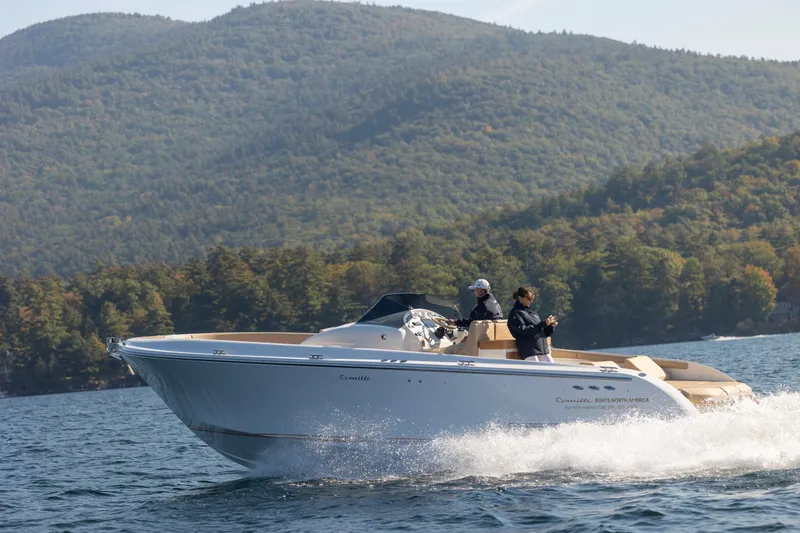 Slide: The Image of 2022 Comitti ISOLA 33 Sport SD cruising on a lake with forested hills in the background. - 30