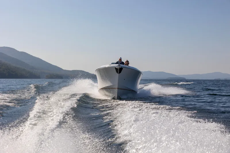 Slide: The Image of 2022 Comitti ISOLA 33 Sport SD speeding on a lake with mountains in the background. - 35