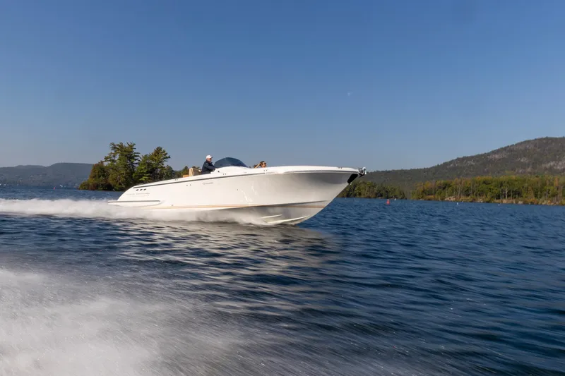 Slide: The Image of 2022 Comitti ISOLA 33 Sport SD speedboat cruising on a scenic lake. - 37