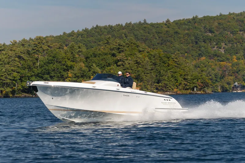 Slide: The Image of 2022 Comitti ISOLA 33 Sport SD cruising on a lake with forested hills in the background. - 39