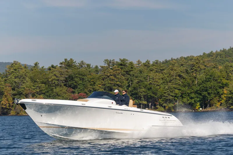 Slide: The Image of 2022 Comitti ISOLA 33 Sport SD cruising on a lake with forested background. - 40