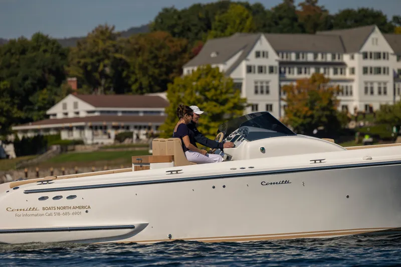 Slide: The Image of 2022 Comitti ISOLA 33 Sport SD cruising near waterfront buildings. - 49