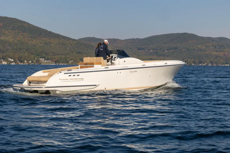 Slide: The Image of 2022 Comitti ISOLA 33 Sport SD cruising on a lake with scenic mountain backdrop. - 6