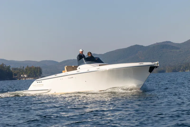 Slide: The Image of 2022 Comitti ISOLA 33 Sport SD cruising on a lake with scenic mountain backdrop. - 8