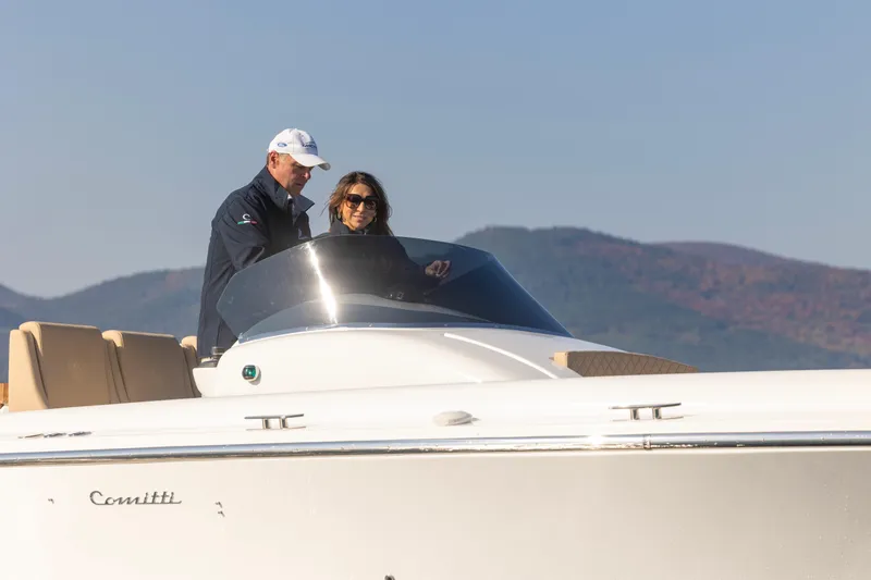 Slide: The Image of 2022 Comitti ISOLA 33 Sport SD boat with two people onboard. - 9