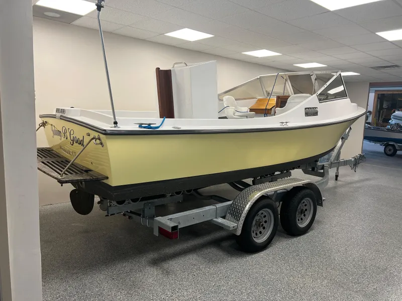 Slide: The Image of 1983 Shamrock 200 Open boat on a Load Rite trailer in an indoor setting. - 2