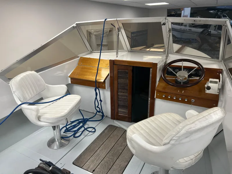 Slide: The Image of 1983 Shamrock 200 Open boat on a trailer in an indoor showroom. - 3