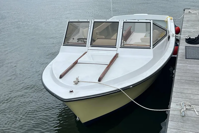 Slide: The Image of 1983 Shamrock 200 Open boat cruising on a lake near a residential shoreline. - 6