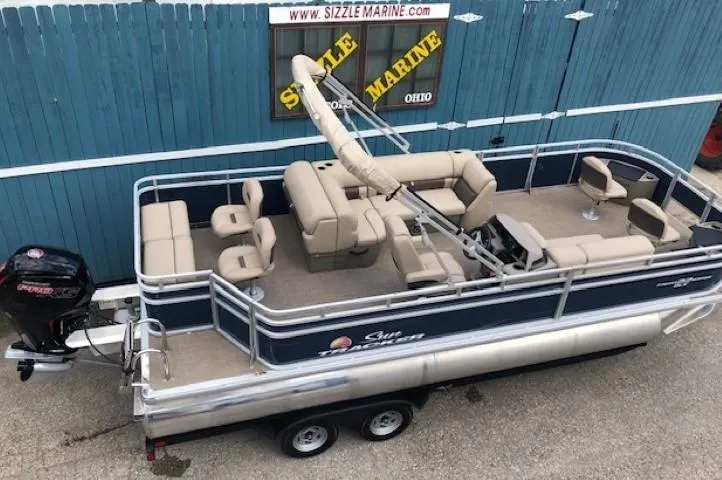 Slide: The Image of 2024 Sun Tracker Fishin' Barge 22 DLX pontoon boat with beige seating and blue exterior. - 5