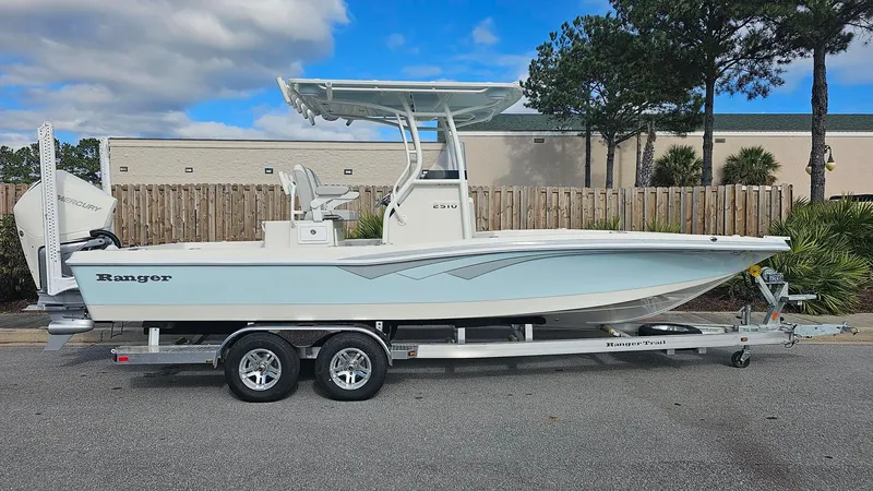 Slide: The Image of 2024 Ranger 2510 Bay boat on a trailer, side view, outdoors. - 1