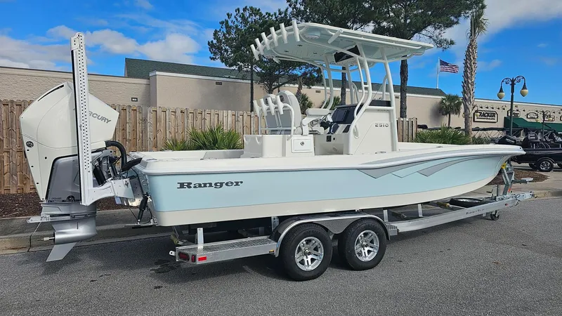 Slide: The Image of 2024 Ranger 2510 Bay boat on trailer, side view, outdoors. - 4
