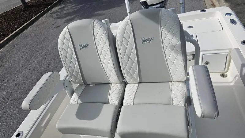 Slide: The Image of 2024 Ranger 2510 Bay boat with luxurious white leather seats. - 6